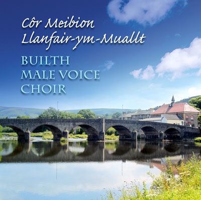 A stone bridge and its reflection cross calm water beneath a blue, clouded sky, with title lettering above.